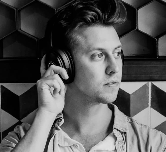 man listening to music with headphones on